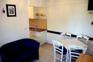 a kitchen with a table and chairs and a sink at MiraMar Gardenn Apartmment in Rab