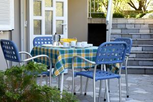 a table and chairs on a patio at MiraMar Gardenn Apartmment in Rab