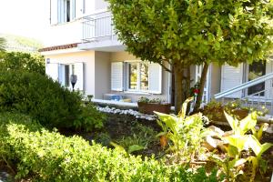 a house with a garden in front of it at MiraMar Gardenn Apartmment in Rab