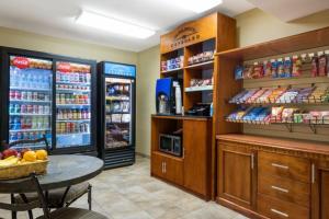 a grocery store with a table in front of two refrigerators at Candlewood Suites LAX Hawthorne by IHG in Hawthorne
