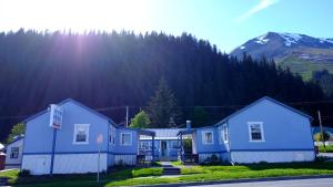 a row of houses in front of a mountain at The Tides Inn in Seward