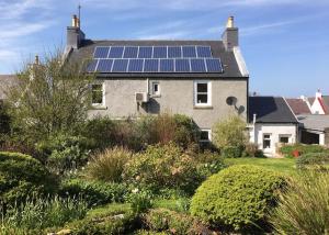 a house with solar panels on the roof at An Cuan Bed & Breakfast in Bowmore