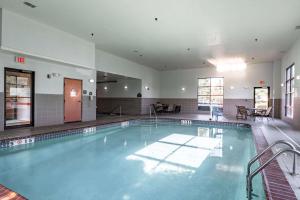 a large swimming pool in a building at Wingate by Wyndham Parkersburg - Vienna in Parkersburg