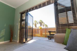 a living room with a large sliding glass door at Salty Corner Cottage Swakopmund in Swakopmund