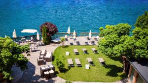 an aerial view of a patio with chairs and the water at Landhotel Schützenhof in Fuschl am See