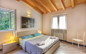 a bedroom with a bed and a tv and two windows at Holiday Pianamaggio in Carrara