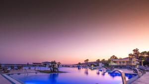 a pool at a resort with the ocean in the background at Azul Beach Resort Montenegro by Karisma - All Inclusive in Ulcinj