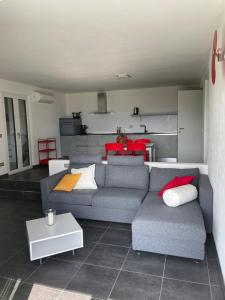 a living room with a gray couch and a table at La Filanda di Viano in Villa in Tremezzo