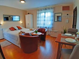 a bedroom with a bed and a table and chairs at Apartments Rupec in Poreč