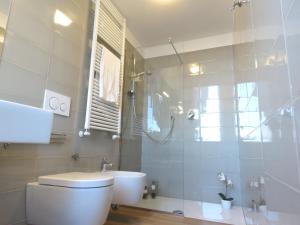 a bathroom with a toilet and a sink and a shower at Lazzaretto Apartments in Bologna