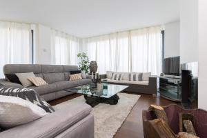 a living room with a couch and a table at El Soto de Sojuela Luxury Chalet, Golf&Bosque in Sojuela