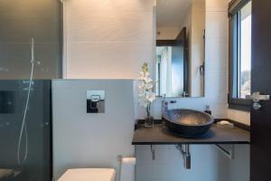 a bathroom with a sink and a mirror at El Soto de Sojuela Luxury Chalet, Golf&Bosque in Sojuela +36 photos