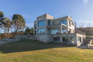 a large house with a lawn in front of it at El Soto de Sojuela Luxury Chalet, Golf&Bosque in Sojuela