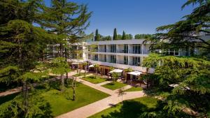 an aerial view of a hotel with trees at Azul Beach Resort Montenegro by Karisma - All Inclusive in Ulcinj