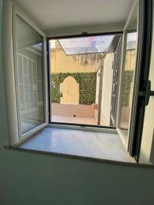 an open window with a view of a yard at B&B Aria di Sole in Naples