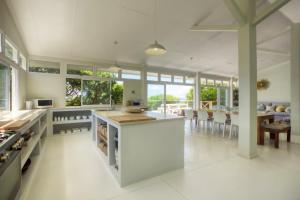 a large kitchen with a counter and a dining room at Kangela 4 in Ponta Malongane