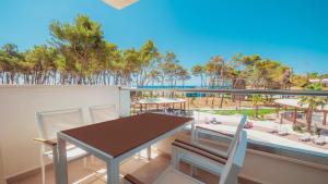 a balcony with a table and chairs and a view of the ocean at Azul Beach Resort Montenegro by Karisma - All Inclusive in Ulcinj