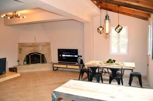 a living room with a table and a fireplace at Villa Stamatis in Áyioi Apóstoloi