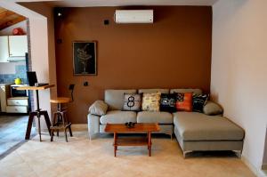 a living room with a couch and a table at Villa Stamatis in Áyioi Apóstoloi