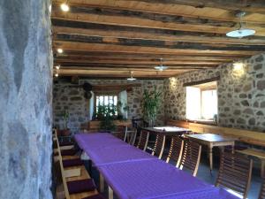 a room with tables and chairs with purple mats at Gruberhof in San Genesio Atesino