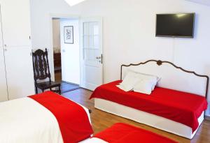 a hotel room with two beds and a television at B&B ViaCavourSei in Portogruaro