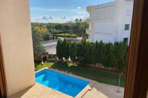 a view of a swimming pool from a building at Apartamento Portobello in Port de Pollensa