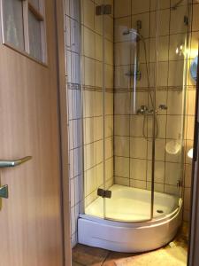 a shower with a glass door in a bathroom at U Kaczorka in Ruciane-Nida +52 photos