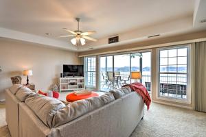 a living room with a couch and a large window at Panorama Waterfront Paradise Condo with Patio! in Lake Ozark