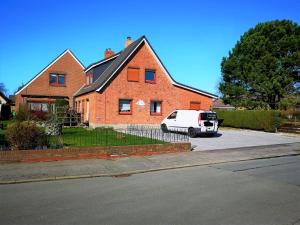 a white van parked in front of a brick house at Wohnung "Burgtiefe" in Bannesdorf auf Fehmarn in Fehmarn