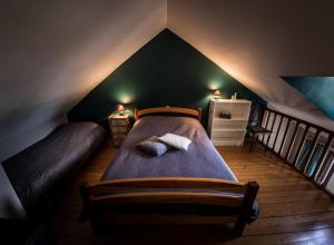 a bedroom with two beds in a attic at B&B La Grange in Durbuy