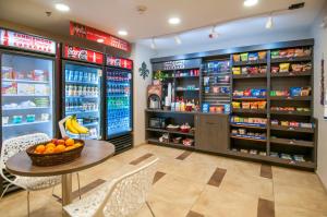 a grocery store with a table and a bowl of oranges at Candlewood Suites - Baton Rouge - College Drive by IHG in Baton Rouge