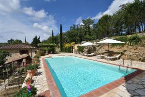 a swimming pool in a yard with a house at Il Poggetto a Vescinino in Radda in Chianti