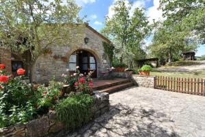 dom z płotem i kwiatami przed nim w obiekcie Il Poggetto a Vescinino w mieście Radda in Chianti