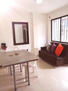 a living room with a table and a couch at Apartamento completo medellin in Medellín