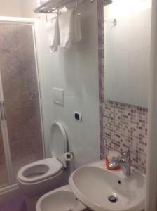 a bathroom with a toilet and a sink and a shower at Guglielmo Marconi House in Rome +24 photos