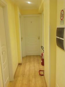 an empty hallway with a white door and wooden floors at Guglielmo Marconi House in Rome