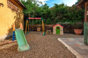 a playground with a slide and a play structure at Casale del Lago in San Casciano in Val di Pesa