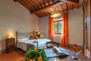 a bedroom with a bed and a table with a table sidx sidx at Casale del Lago in San Casciano in Val di Pesa +40 photos