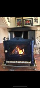 a fireplace with a fire inside of it at Villa ain soltan in Imouzzer du Kandar