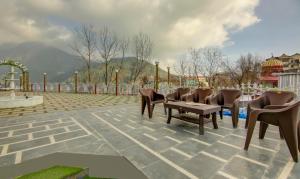 a group of chairs and a table on a patio at The Alpine Villa Mcleodganj in McLeod Ganj
