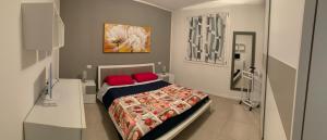 ein Schlafzimmer mit einem Bett mit zwei roten Kissen in der Unterkunft Le Noir appartment in Peschiera del Garda