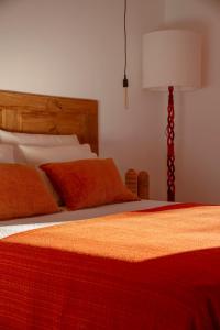 a bedroom with two beds with a lamp and a bed sidx sidx sidx at Quinta da Pintassilga in Tavira