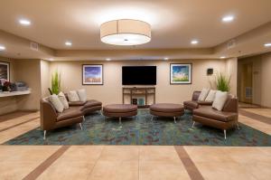 a lobby with couches and a flat screen tv at Candlewood Suites - Baton Rouge - College Drive by IHG in Baton Rouge