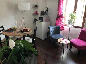 - un salon avec une table et des chaises ainsi qu'une salle à manger dans l'établissement L'AMARILYS chambre d'hôte, à Châteauneuf-du-Pape