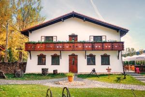 a house with a balcony on top of it at Wolkendorf Bio Hotel & Spa in Braşov