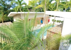 una casa con palmeras delante en BOHO Tamarindo en Tamarindo