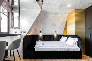 a bedroom with a black bed and a yellow wall at BLACK BEAR in Gdańsk
