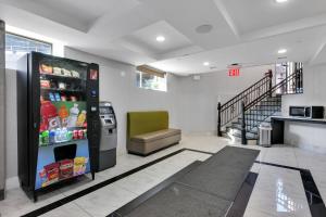 a large refrigerator in a room with a staircase at Hotel Mint JFK Airport in Queens