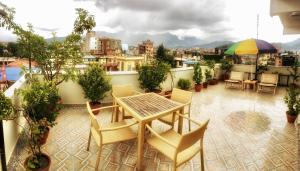 a patio with a table and chairs on a balcony at Yeti Inn Pvt. Ltd. in Kathmandu