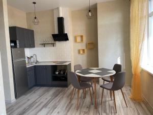 a kitchen with a table and chairs in a room at Apartment Riviera in Fontanka